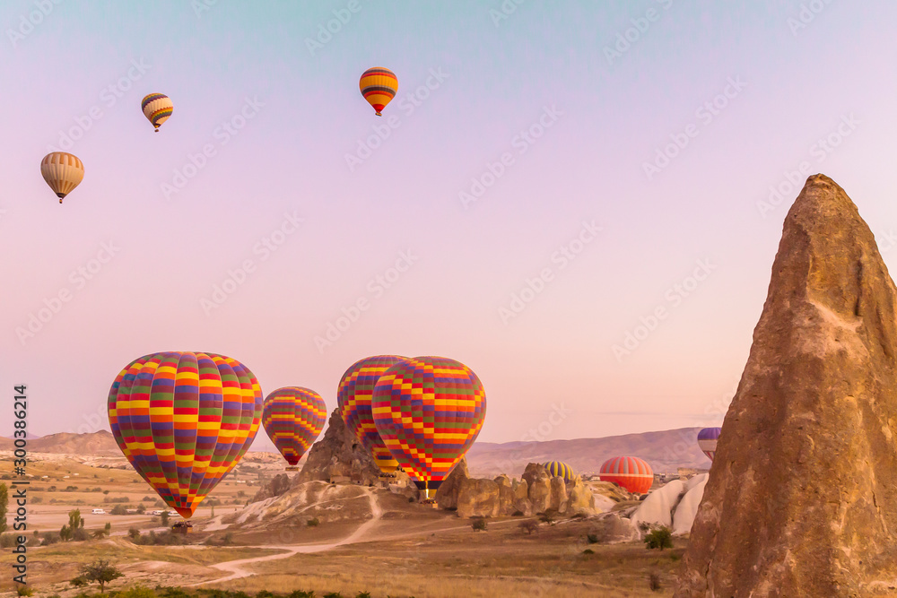 Colourful hot air balloons launching at sunrise in Cappadocia