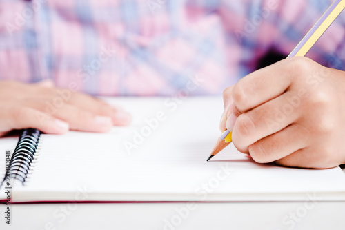 Child Start Writing on Notebook