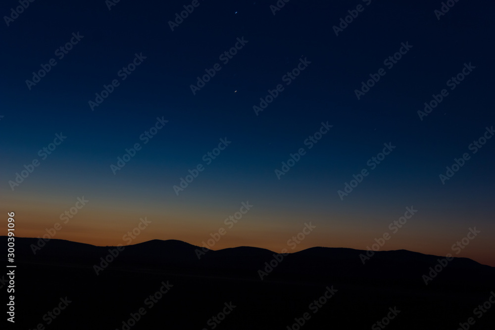Sunset landscape view of silhouette mountains