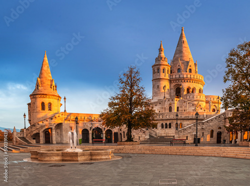 Budapest, Hungary - Golden hour at Fisherman's Bastion on an autumn morning with blue sky, orange and yello foliage