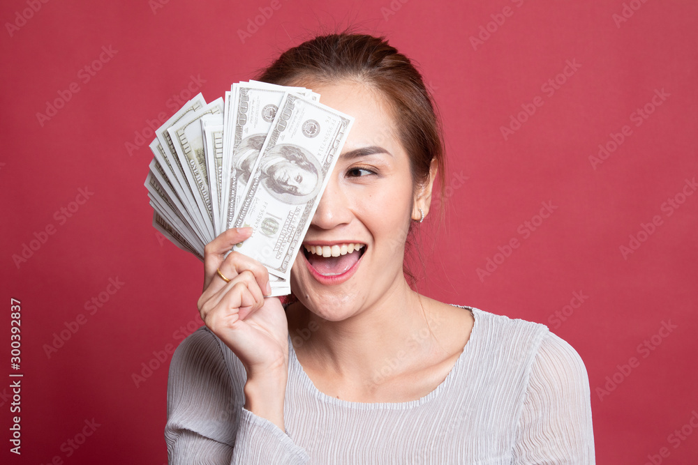 Portrait of young asian woman showing bunch of money banknotes. Portrait of young asian woman showing bunch of money banknotes.