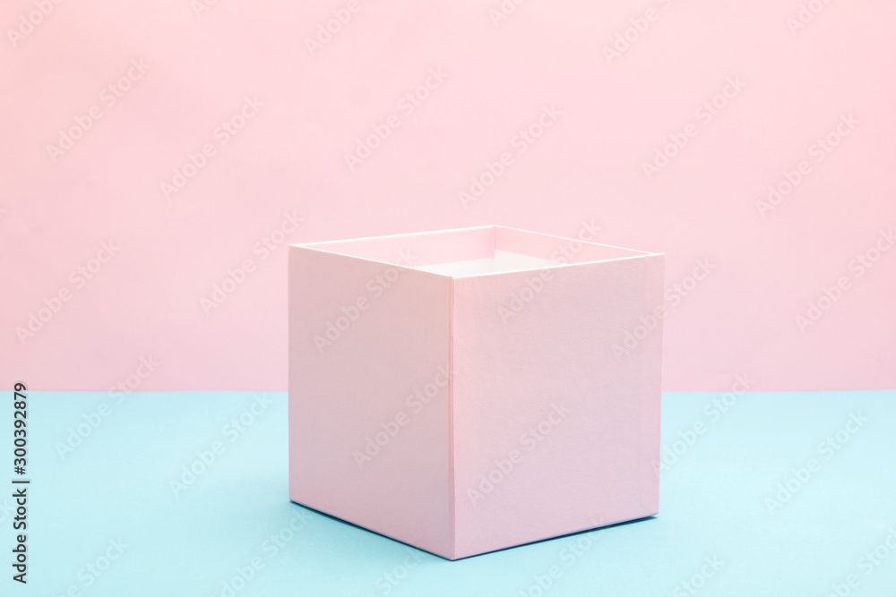 Obraz premium Empty, open white gift box on blue background with copy space