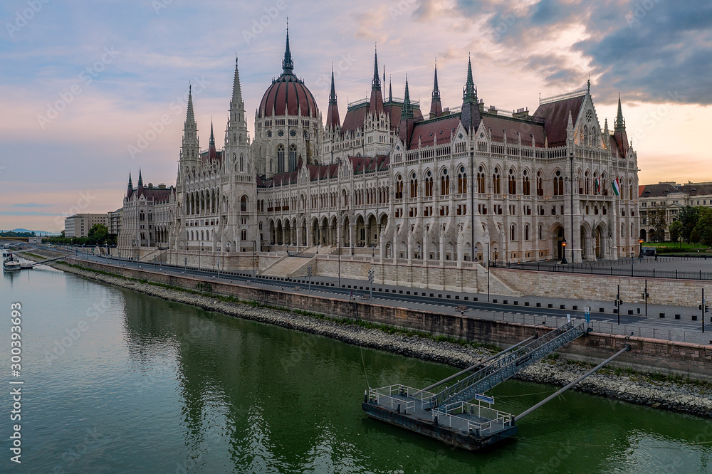 Aerial view of the beautiful Hungarian Parliament building by River Danube on a bright summer day with blue sky and clouds