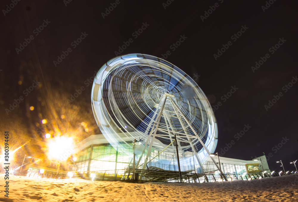 The long exposure Ferris wheel. Circular carousel background.