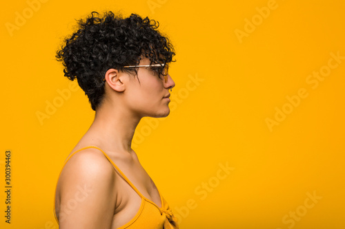 Young african american woman with skin birth mark gazing left, sideways pose.