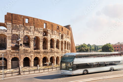 Canvas Print Touristy travel white bus Rome Colosseum sunny morning