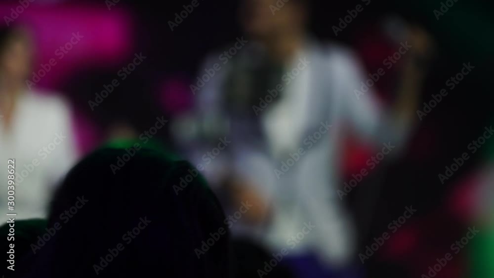 People dancing at the party. Unrecognizable silhouette crowd in nightclub with disco light. People dancing at the party. Unrecognizable silhouette crowd in nightclub with disco light.