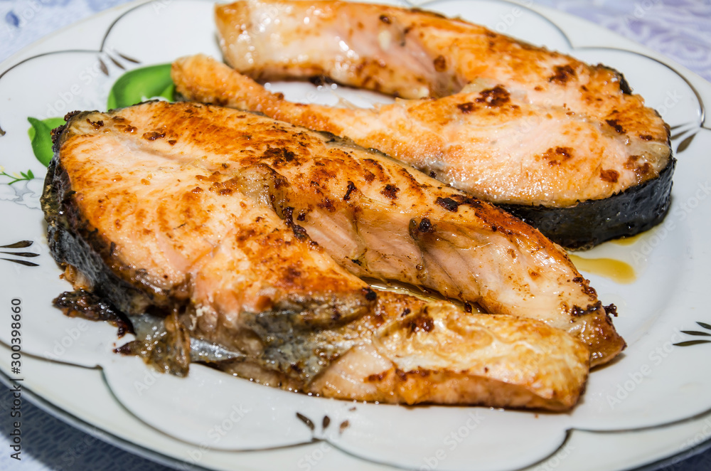 red fish in a plate, closeup. Grilled salmon.