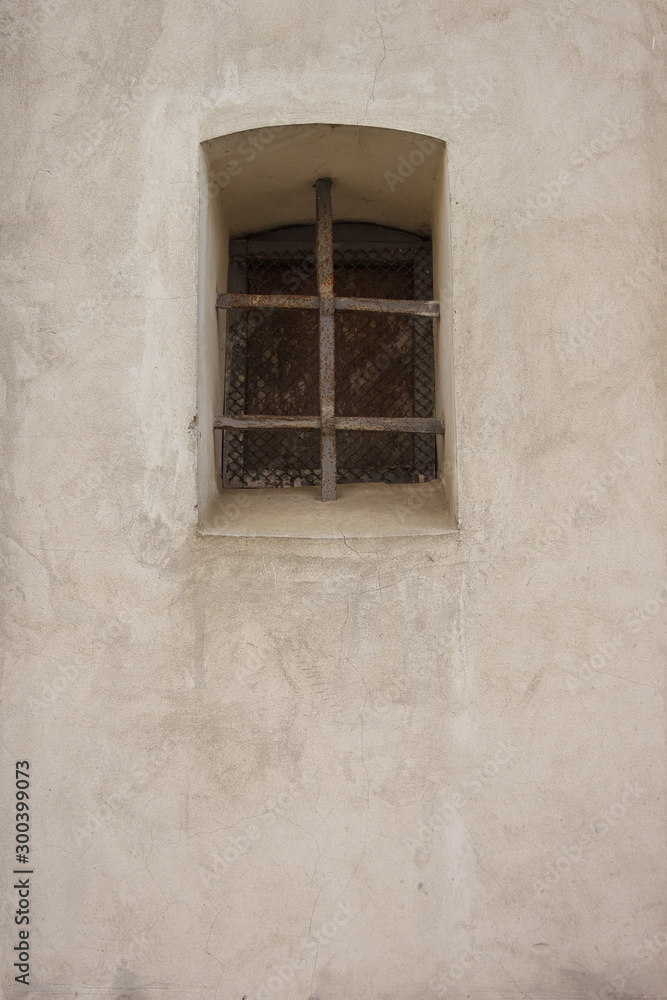 Latticed window in the wall of a Catholic church