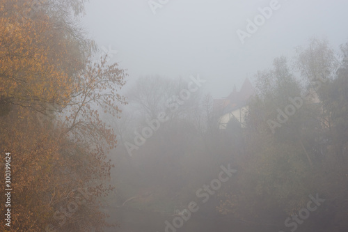 Thick fog over the river. Autumn landscape