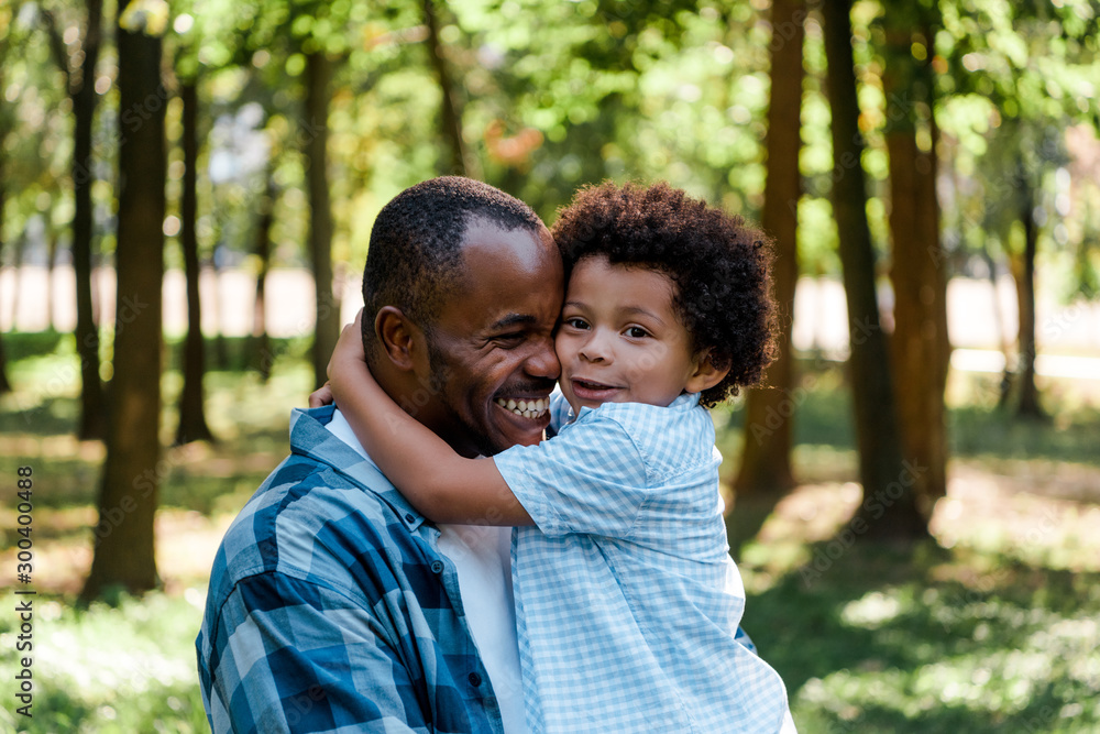 cute african american kid hugging happy father Stock Photo | Adobe Stock