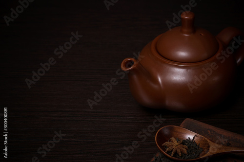 Wallpaper Mural Clay teapot on a dark wooden table. Nearby are tea leaves on a plate. Torontodigital.ca