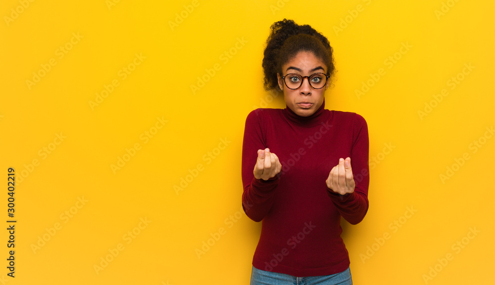 Young black african american girl with blue eyes doing a gesture of need - obrazy, fototapety, plakaty 