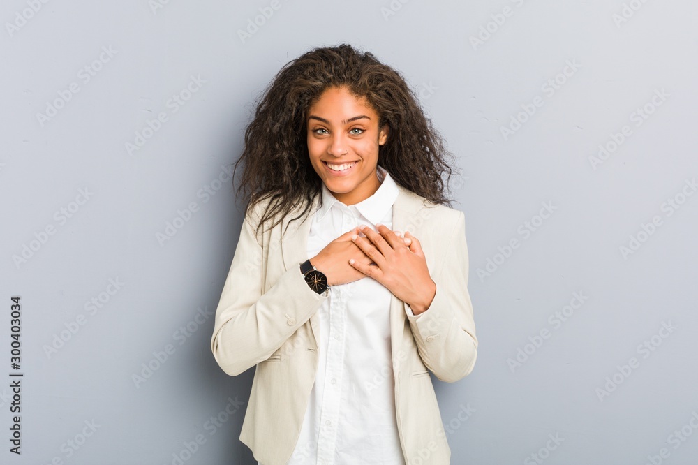 Young african american business woman has friendly expression, pressing palm to chest. Love concept. Young african american business woman has friendly expression, pressing palm to chest. Love concept.