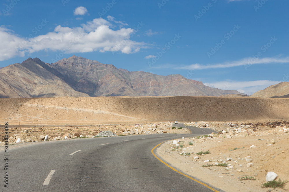 Curve asphalt road leading to big high mountain