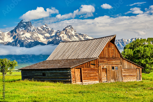 Old mormon barn in Grand Teton Mountains with low clouds. Grand Teton National Park, Wyoming, USA. © haveseen