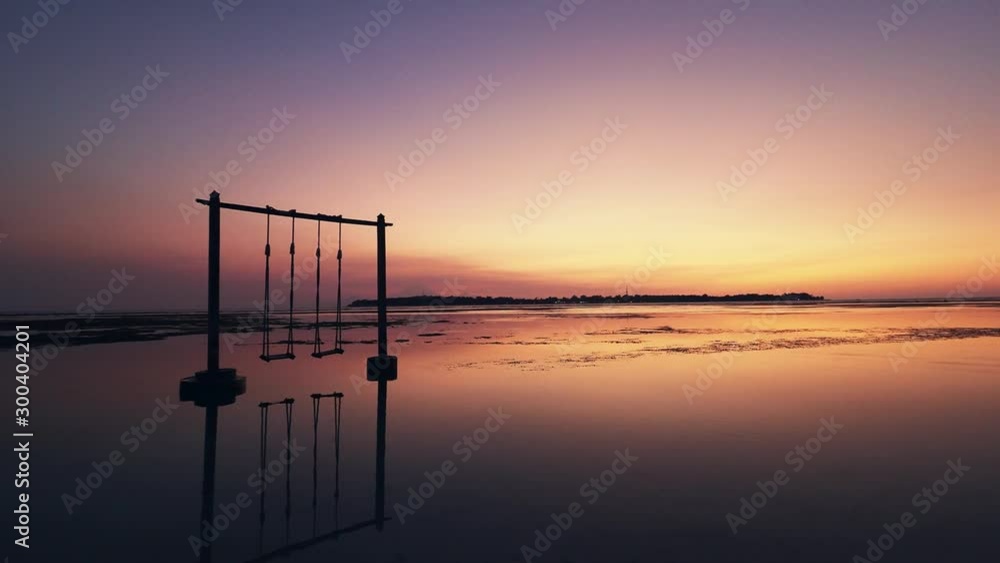 Silhouette of giant swing with sunset background 
