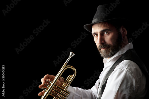 trumpet man with beard portrait on black