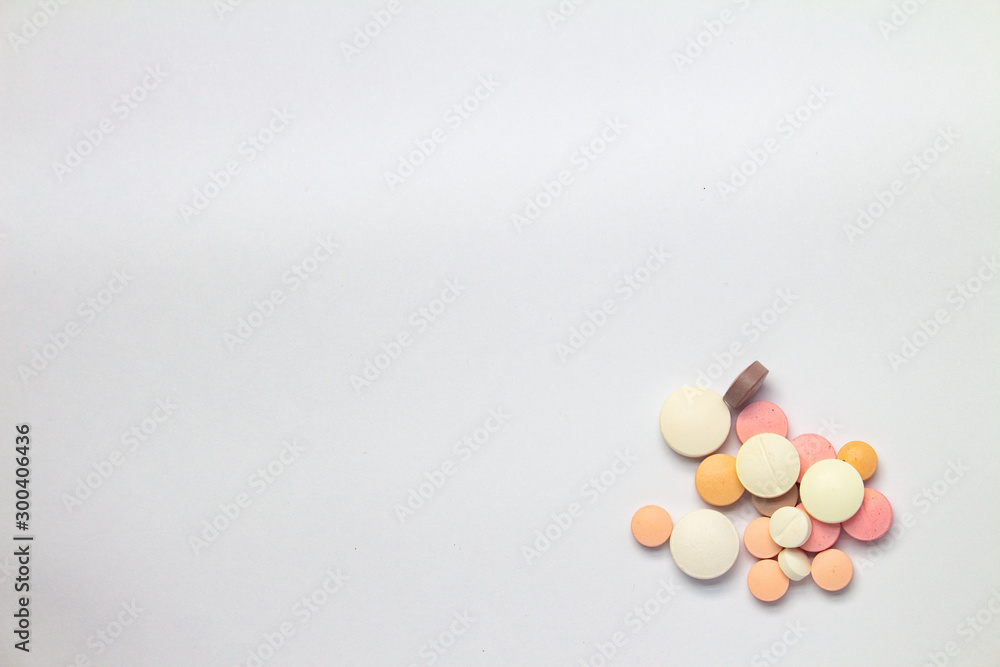 Colored pills on white background. Concept of medication abuse. Colored pills on white background. Concept of medication abuse.
