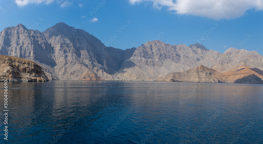 Spectacular panorama of the fjords and rocky mountains and blue waters of Khasab, Musandam, Oman in the Middle East near the Strait of Hormuz.