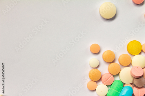 Colored pills on white background. Concept of medication abuse.