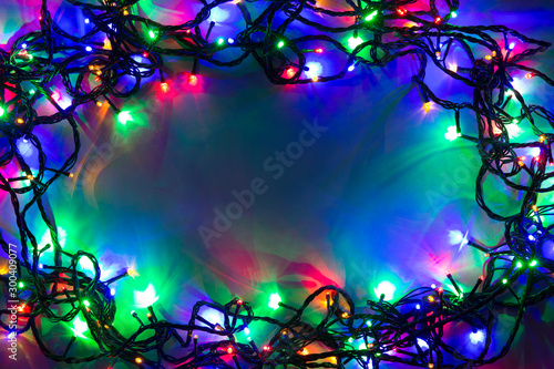 Christmas background with lights and free text space. Christmas lights. Glowing colorful Christmas lights . New Year. Garland.