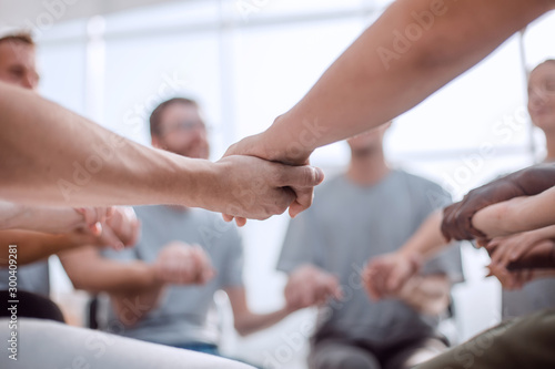 background image is a group of people holding each other's hands.