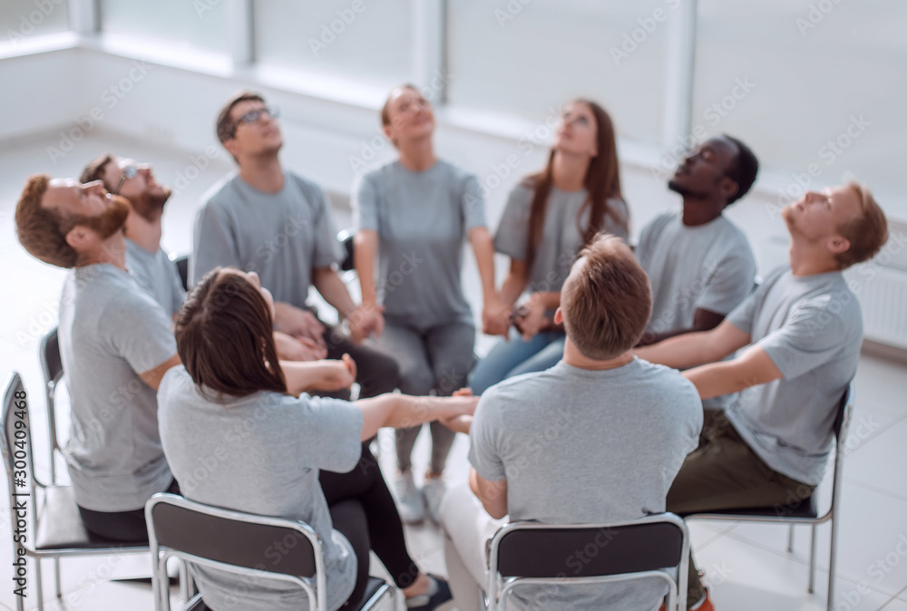 group of concentrated people sitting in a circle.