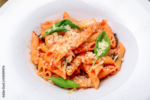 Penne pasta with shrimp and mussels, tomato sauce, basil and grated parmesan cheese
