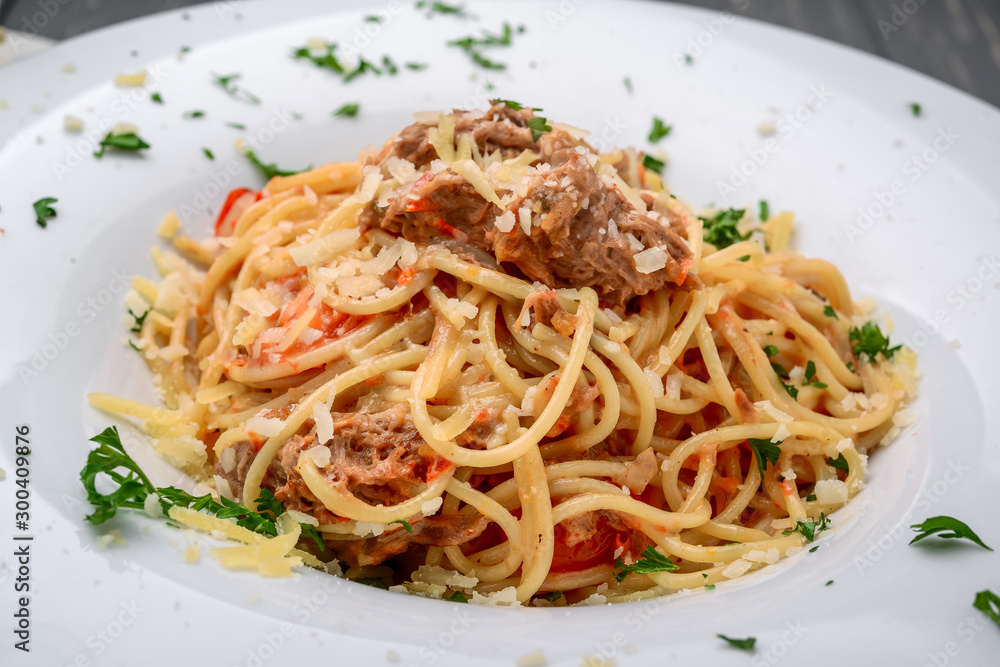 spaghetti dinner with meat sauce and basil close up