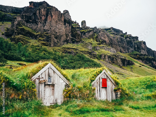 Grass covered wooden houses in Nupstadur in Iceland with moody weather