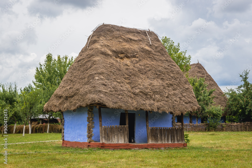 Traditional blue cottage made of wood, straw and clay in Oas County heritage park in Negresti-Oas, Romania