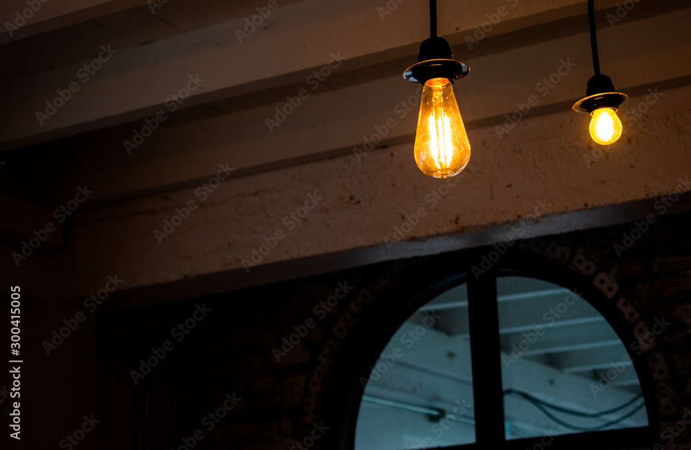 Light bulb illuminated in a dark room.
