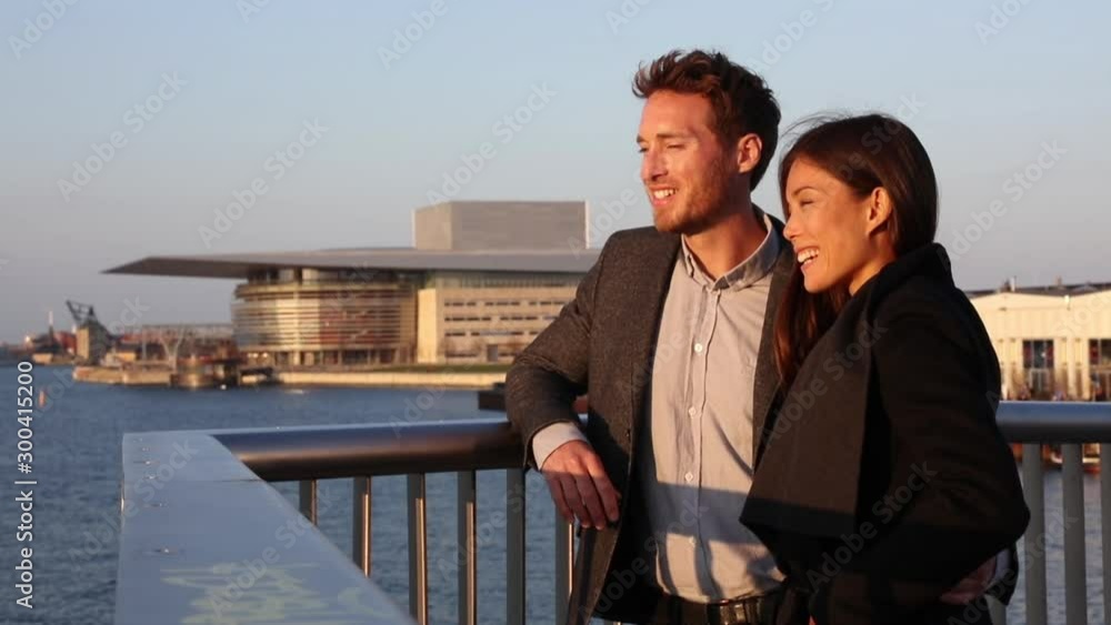 Europe couple enjoying sunset view at Copenhagen harbourfront by the Opera house, Denmark european holiday lifestyle. Asian woman, Danish man interracial people. Travel tourists. Europe couple enjoying sunset view at Copenhagen harbourfront by the Opera house, Denmark european holiday lifestyle. Asian woman, Danish man interracial people. Travel tourists.