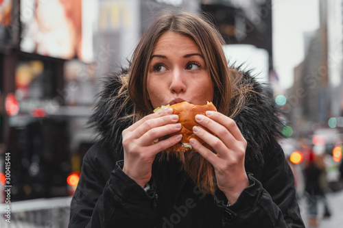 woman has fun with junk food in the city of new york