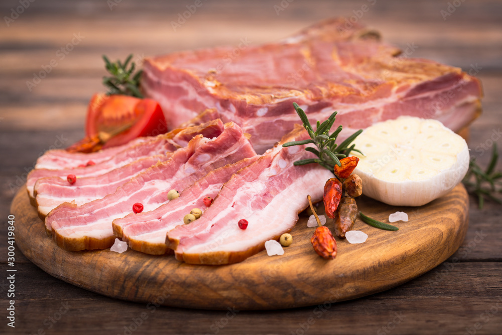 Homemade smoked bacon on wooden board Homemade smoked bacon on wooden board