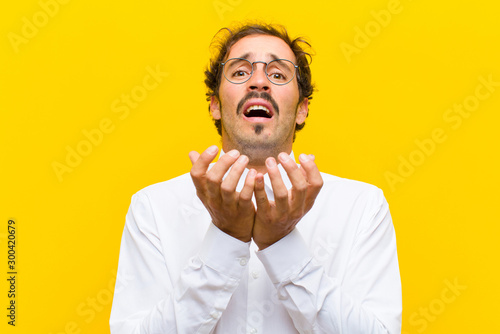 Fotografie young handsome man looking desperate and frustrated, stressed, unhappy and annoy