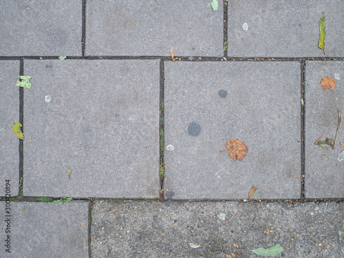 Looking down at grey concrete paving slabs
