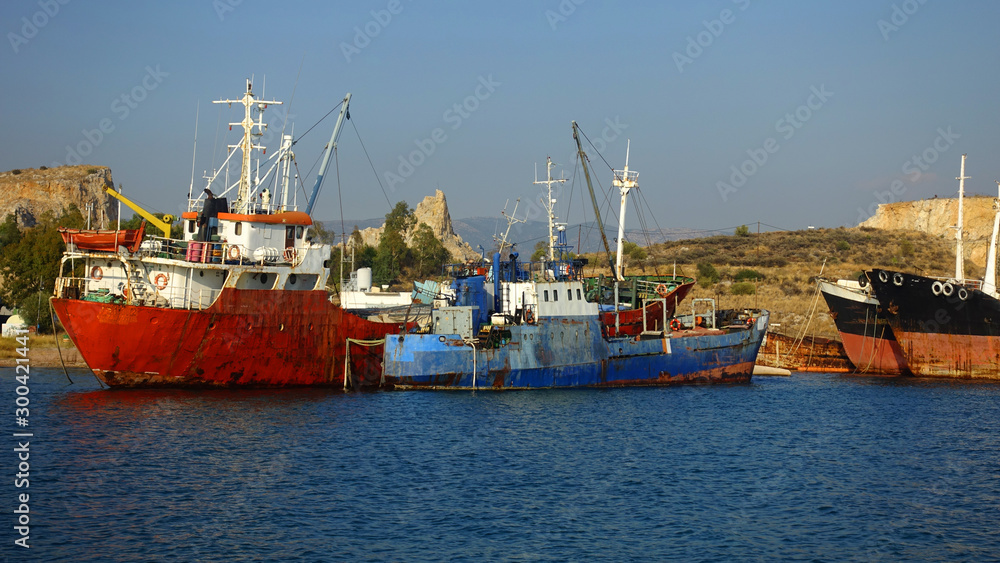 Old abandoned shipyard with scrap boats left to rust in Elefsina area, Attica, Greece