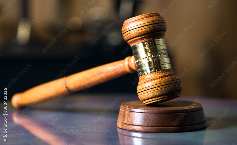 Law and Justice concept. Mallet of the judge, books, scales of justice. Gray stone background, reflections on the floor, place for typography. Courtroom theme. Law and Justice concept. Mallet of the judge, books, scales of justice. Gray stone background, reflections on the floor, place for typography. Courtroom theme.