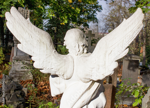 The back of an angel in the cemetery. The guard of the dead
