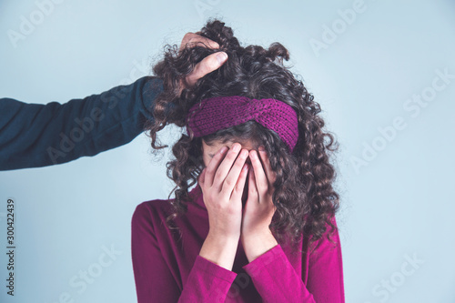 man hand in sad woman hair