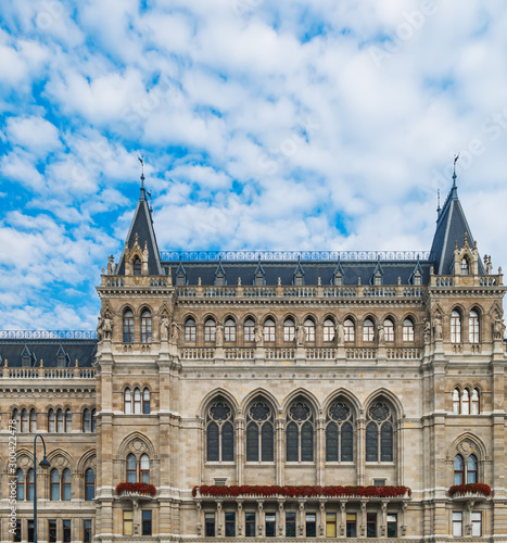 Beautiful facade of Town Hall or Rathaus under blue cloudy sky in Vienna, Austria photo