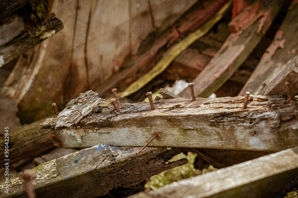 Rusty nails and wood, view inside a derelict shipwreck, seen in King's Lynn, Norfolk, England, UK Rusty nails and wood, view inside a derelict shipwreck, seen in King's Lynn, Norfolk, England, UK