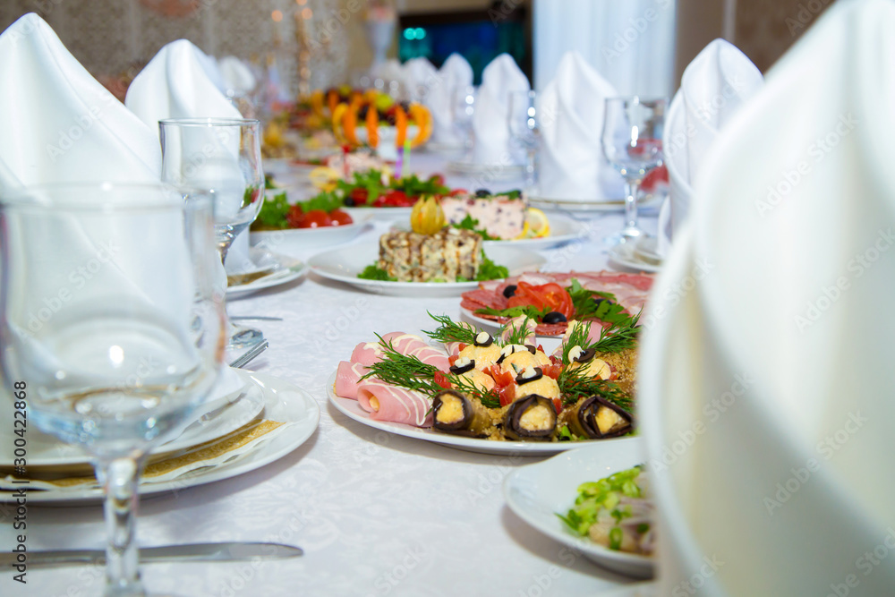 Beautiful festive table setting. Delicious snack on their plates