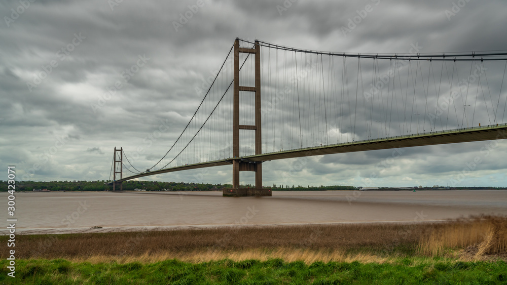 Grey clouds over the Humber Bridge, seen from Barton-Upon-Humber in North Lincolnshire, England, UK