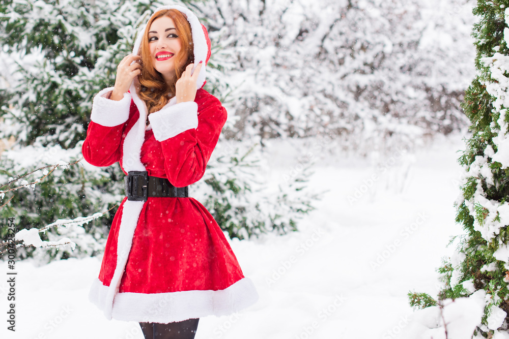 Christmas or New Year Holidays, magical atmosphere and pretty woman at snowy day. Inspiration and winter idea Christmas or New Year Holidays, magical atmosphere and pretty woman at snowy day. Inspiration and winter idea