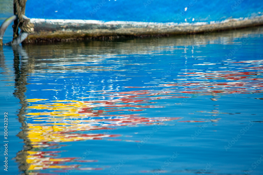 Traditional Malta fishing boat luzzu reflection in water