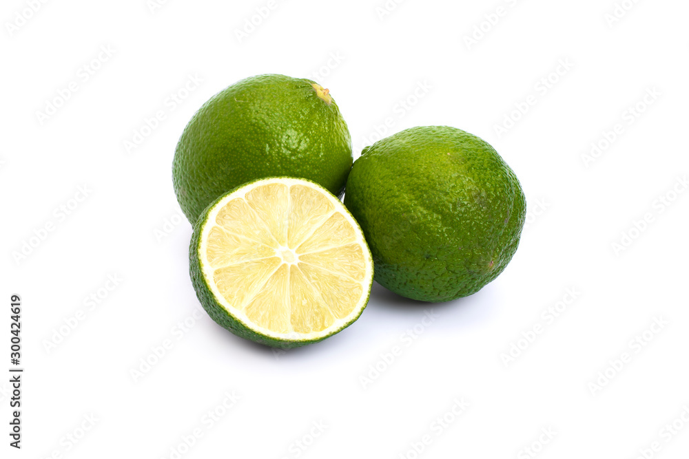 Lime green on a white background. Whole and halves limes isolated on white background. Full depth of field. Lime green on a white background. Whole and halves limes isolated on white background. Full depth of field.
