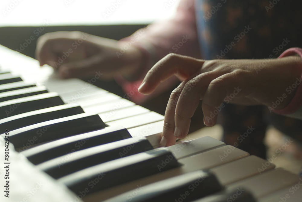 Fototapeta premium children's hands are playing the piano